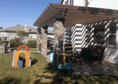A patio with a wooden pergola.