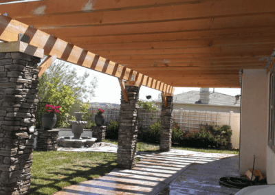 A patio with a bench and a table.