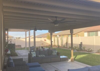 A patio covered with furniture and a grill.